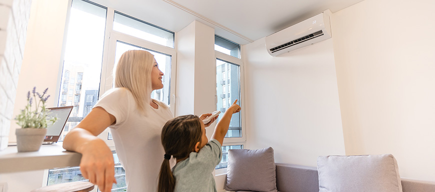 Mother and daughter adjusting AC